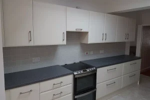 676 black oven and countertops with white fitted kitchen cabinets