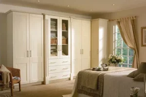 bedroom2-1920w bedroom with white wardrobe cabinets and a bed with partially opened window